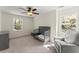 Bright room with neutral decor, a ceiling fan, a crib, and a gray dresser providing a cozy and versatile space at 385 Jayne Ellen Way, Alpharetta, GA 30009