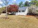 Charming two-story home with white siding, a red door, and a inviting front porch at 385 Jayne Ellen Way, Alpharetta, GA 30009