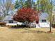 Charming home with well-maintained lawn, a beautiful red Japanese maple, and a welcoming front porch at 385 Jayne Ellen Way, Alpharetta, GA 30009