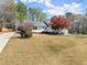 Well-kept home with a sprawling front yard, mature tree, and inviting front porch, blending comfort and charm at 385 Jayne Ellen Way, Alpharetta, GA 30009