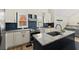 Eat-in kitchen featuring granite counters, stainless appliances, blue backsplash, and modern hardware at 385 Jayne Ellen Way, Alpharetta, GA 30009