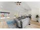 Open-concept living room features recessed lighting, a large sectional sofa, and connection to the kitchen at 385 Jayne Ellen Way, Alpharetta, GA 30009