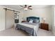 Cozy main bedroom with a ceiling fan, a barn door, and neutral decor providing a relaxing retreat at 385 Jayne Ellen Way, Alpharetta, GA 30009
