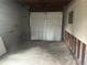 Spacious garage with a white door; ideal for parking and storage solutions, ready for use at 3025 Mckenzie Rd, Atlanta, GA 30344