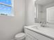 Modern half bath featuring white cabinets, brushed nickel faucet, and quartz counters at 373 Riverwood Pass, Dallas, GA 30157