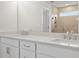 Bathroom with double sink vanity, stone countertop, and tiled shower with window at 373 Riverwood Pass, Dallas, GA 30157