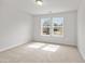 Bright bedroom featuring two windows and neutral carpet at 373 Riverwood Pass, Dallas, GA 30157