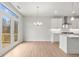 Dining area features French doors leading to a deck, wood floors, and contemporary lighting at 373 Riverwood Pass, Dallas, GA 30157