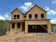 Exterior of a new construction home featuring unfinished wood and a spacious two-car garage at 373 Riverwood Pass, Dallas, GA 30157