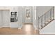 Entryway with wood flooring, staircase, and a view into the modern kitchen at 373 Riverwood Pass, Dallas, GA 30157