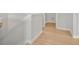 Bright hallway with light walls and trim, and laminate wood floors at 373 Riverwood Pass, Dallas, GA 30157