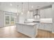 Open-concept kitchen featuring a spacious island, stainless steel hood, and access to a deck at 373 Riverwood Pass, Dallas, GA 30157