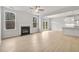 Open concept living room and kitchen area with fireplace, wood-look floors, and lots of natural light at 373 Riverwood Pass, Dallas, GA 30157