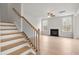 Cozy living room with fireplace, staircase, and large windows allowing ample natural light at 373 Riverwood Pass, Dallas, GA 30157