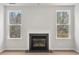 Cozy living room with a fireplace flanked by two large windows showcasing outdoor views at 373 Riverwood Pass, Dallas, GA 30157