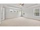 Spacious main bedroom with tray ceiling, fan, and three windows at 373 Riverwood Pass, Dallas, GA 30157