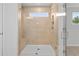 New tiled shower with window, shower seat, and glass door at 373 Riverwood Pass, Dallas, GA 30157