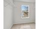 Walk-in closet with carpeted floor, wire racks, and a window for natural light at 373 Riverwood Pass, Dallas, GA 30157