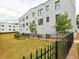Backyard with a grassy area, fence, and view of the building's exterior at 88 Peachtree Memorial Nw Dr # 88, Atlanta, GA 30309