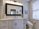 Modern bathroom featuring a large, decorative mirror, sleek white vanity, and updated toilet at 88 Peachtree Memorial Nw Dr # 88, Atlanta, GA 30309