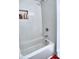 Clean white bathroom with a tiled tub/shower combination and a convenient built-in shelf at 88 Peachtree Memorial Nw Dr # 88, Atlanta, GA 30309