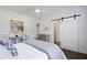 Bedroom showcasing a sliding barn door, neutral decor, and a comfortable bed at 88 Peachtree Memorial Nw Dr # 88, Atlanta, GA 30309