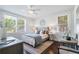 Bright bedroom with two windows, a bed with a tufted headboard, and decorative accents at 88 Peachtree Memorial Nw Dr # 88, Atlanta, GA 30309