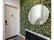 Stylish entryway featuring green foliage wall, gold mirror and stair access at 88 Peachtree Memorial Nw Dr # 88, Atlanta, GA 30309