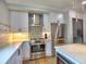 Stylish kitchen with stainless steel appliances, modern backsplash, and white cabinetry at 88 Peachtree Memorial Nw Dr # 88, Atlanta, GA 30309