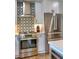 Close up of stainless steel oven and fridge with patterned backsplash in a modern kitchen at 88 Peachtree Memorial Nw Dr # 88, Atlanta, GA 30309
