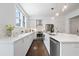 Contemporary kitchen with bright cabinets, stainless steel appliances, and elegant lighting at 88 Peachtree Memorial Nw Dr # 88, Atlanta, GA 30309