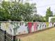 Outdoor mural featuring painted roses and other flowers along a community fence at 88 Peachtree Memorial Nw Dr # 88, Atlanta, GA 30309