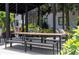 Outdoor dining space with large table, benches, and swings in community area at 88 Peachtree Memorial Nw Dr # 88, Atlanta, GA 30309