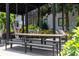 Outdoor dining space with large table, benches, and swings in community area at 88 Peachtree Memorial Nw Dr # 88, Atlanta, GA 30309