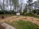 View of the spacious backyard with a small storage shed, grass, and surrounding trees at 920 James Nw Ct, Marietta, GA 30060