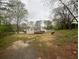 Expansive backyard featuring a deck and a storage shed in a serene, wooded setting at 920 James Nw Ct, Marietta, GA 30060