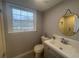 Bathroom with white vanity, round mirror, and neutral color scheme at 920 James Nw Ct, Marietta, GA 30060