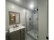 Updated bathroom with sleek walk-in shower, modern vanity, and decorative mirror at 920 James Nw Ct, Marietta, GA 30060