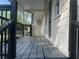 Inviting covered front porch with a charming wood floor and black metal railings at 920 James Nw Ct, Marietta, GA 30060