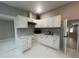 Bright kitchen featuring white cabinets, modern hardware, updated counters, and tile floors at 920 James Nw Ct, Marietta, GA 30060
