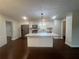 Modern kitchen boasts white cabinets, stainless appliances, and island with stone countertop at 920 James Nw Ct, Marietta, GA 30060