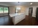 Bright open concept kitchen with island, stainless appliances, and wood floors at 920 James Nw Ct, Marietta, GA 30060