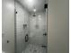 Modern walk-in shower with glass enclosure, sleek fixtures, and tiled walls at 920 James Nw Ct, Marietta, GA 30060