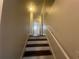 Well-lit staircase with dark treads and white risers connecting multiple levels of the home at 920 James Nw Ct, Marietta, GA 30060
