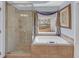 Bathroom features a soaking tub with tile surround and a glass-enclosed shower at 1210 Spring Branch Ct, Lawrenceville, GA 30045