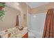 Bright bathroom featuring a single vanity, large mirror and a shower with a curtain, creating a functional space at 1210 Spring Branch Ct, Lawrenceville, GA 30045