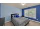 Modern bedroom featuring calming colors, large window and comfortable sleeping arrangements at 1210 Spring Branch Ct, Lawrenceville, GA 30045