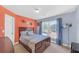 Comfortable bedroom featuring modern lighting, a large window, and calming color scheme at 1210 Spring Branch Ct, Lawrenceville, GA 30045