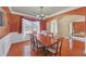 Elegant dining room featuring hardwood floors, ornate lighting and views of the front yard at 1210 Spring Branch Ct, Lawrenceville, GA 30045