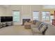 Cozy living room features a fireplace, large windows, and a view of the backyard at 1210 Spring Branch Ct, Lawrenceville, GA 30045